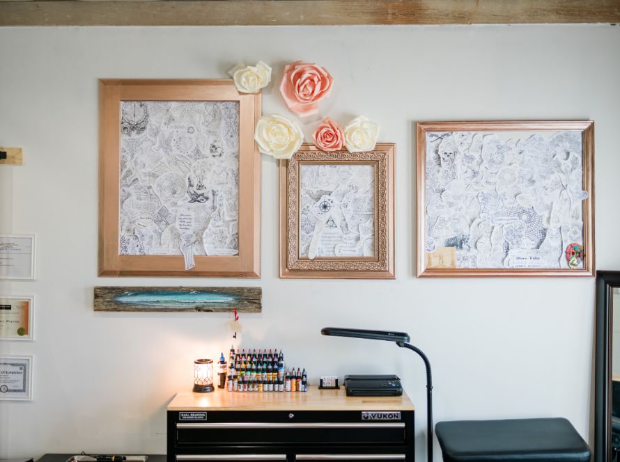 Frame of paper collage on wall, adorned with flowers