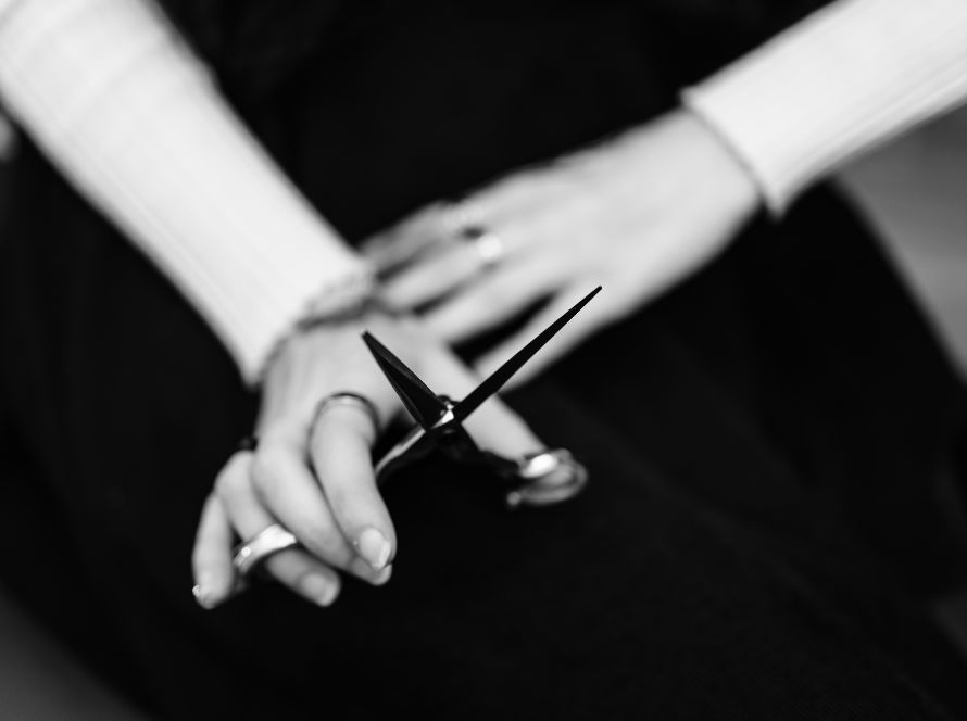 Girl holding scissors in black and white portrait